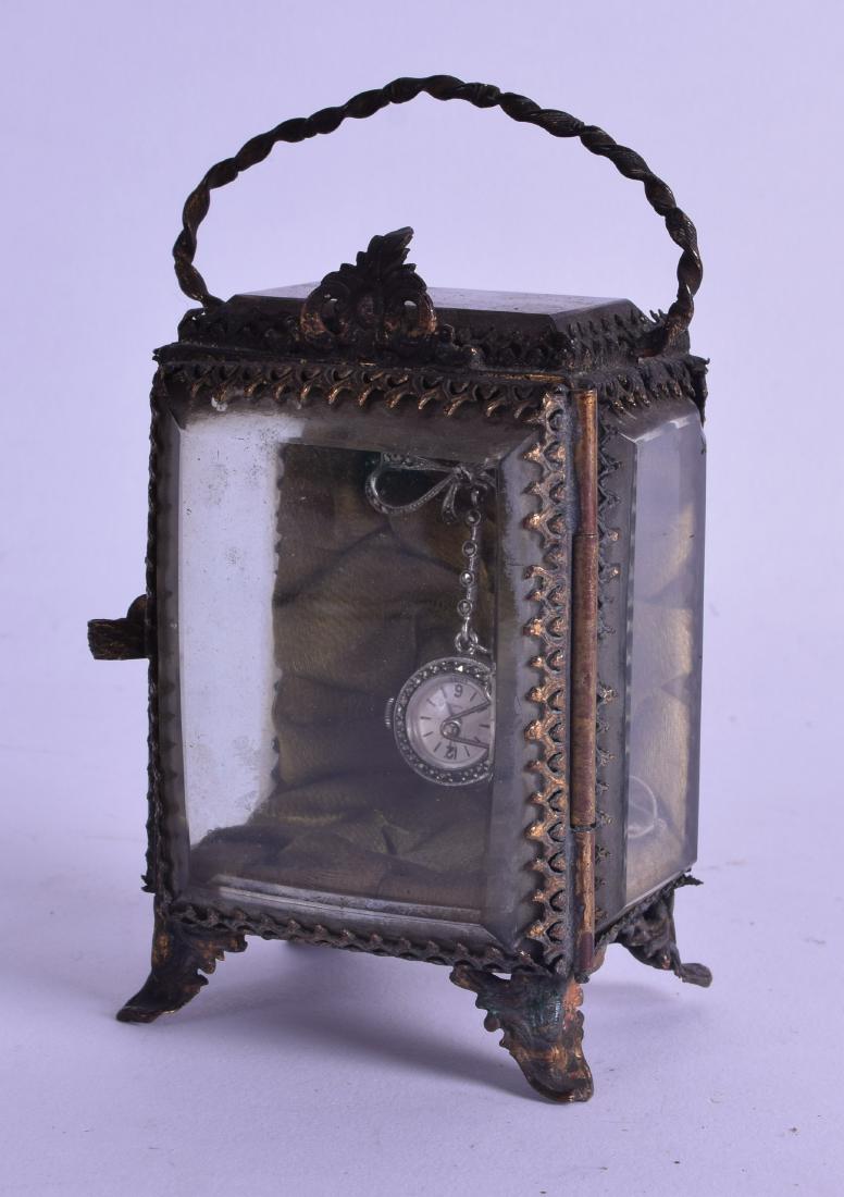 AN EARLY 20TH CENTURY FRENCH SILVER HANGING FOB WATCH: AN EARLY 20TH CENTURY FRENCH SILVER HANGING FOB WATCH within a gilt metal landscape inset watch case. (2)
