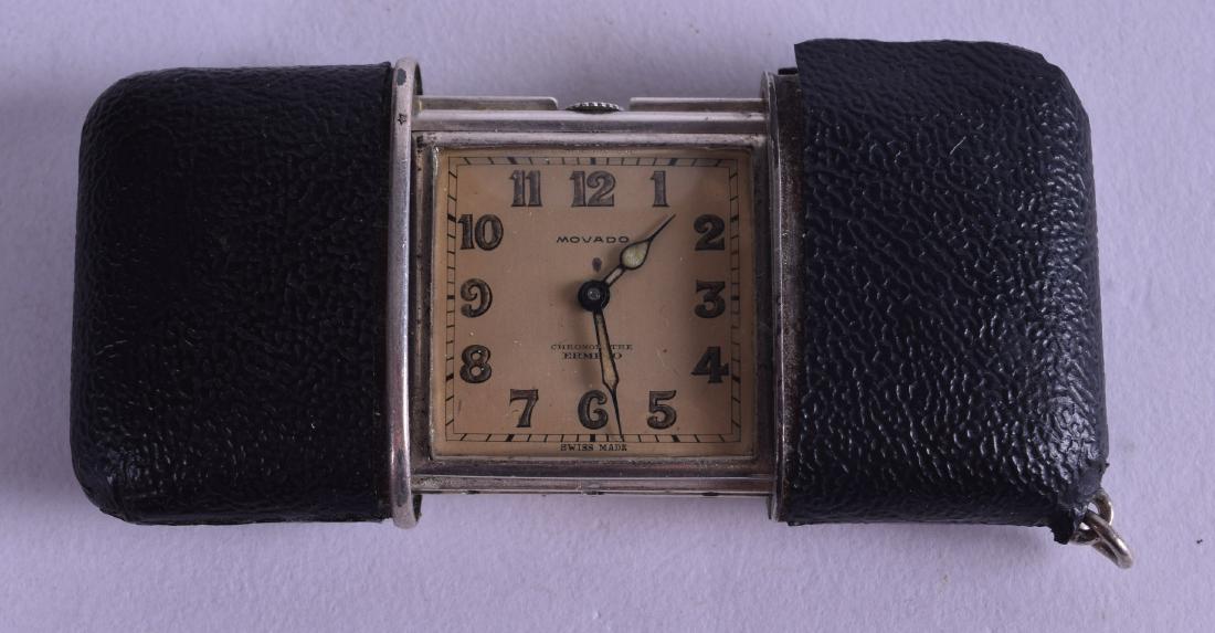 A CONTINENTAL SILVER AND LEATHER CASED MOVADO FOLDING: A CONTINENTAL SILVER AND LEATHER CASED MOVADO FOLDING TRAVELLING WATCH. 7.25 cm wide extended.
