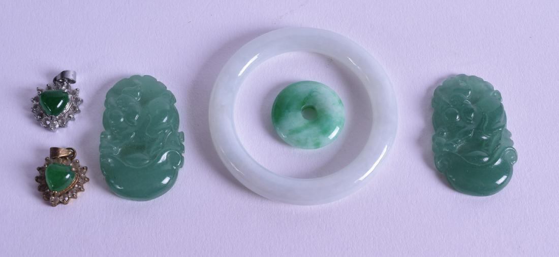 A SMALL CHINESE CARVED JADEITE CHILDS BANGLE together (1 of 2)