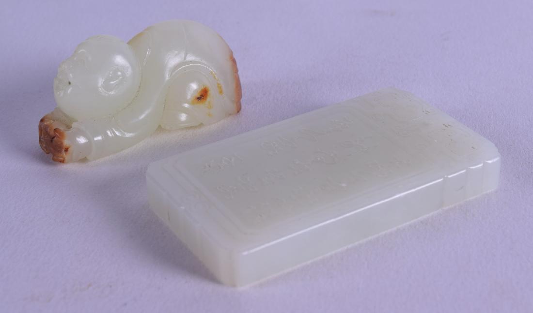 A CHINESE CARVED GREENISH WHITE JADE FIGURE OF A BOY: A CHINESE CARVED GREENISH WHITE JADE FIGURE OF A BOY together with a jade tablet. (2)