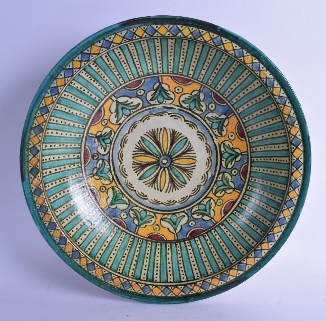 A MIDDLE EASTERN FAIENCE MAJOLICA TYPE CIRCULAR POTTERY: A MIDDLE EASTERN FAIENCE MAJOLICA TYPE CIRCULAR POTTERY BOWL painted with stylised flowers. 33 cm diameter.
