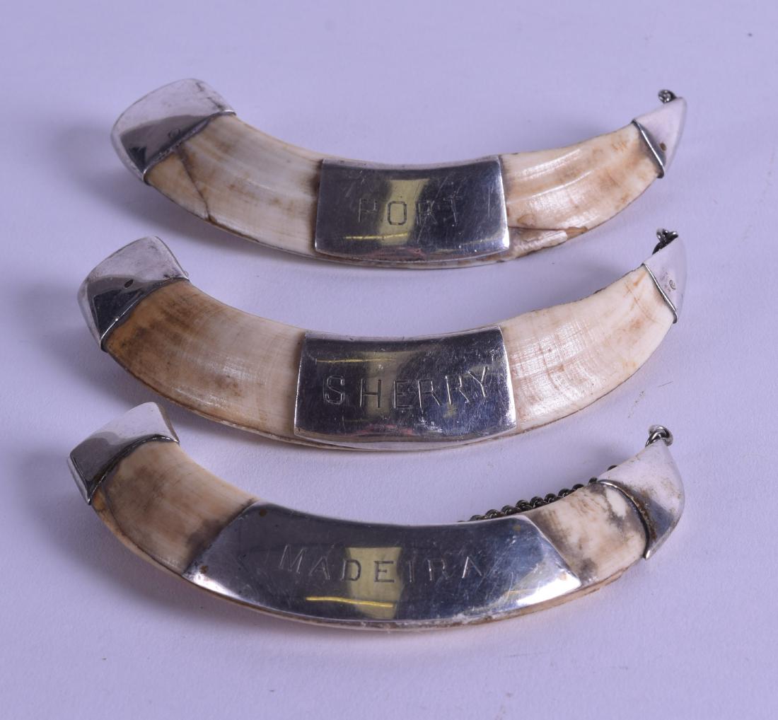 AN UNUSUAL SET OF THREE LATE VICTORIAN SILVER MOUNTED: AN UNUSUAL SET OF THREE LATE VICTORIAN SILVER MOUNTED DECANTER LABELS. 12.5 cm long. (3)