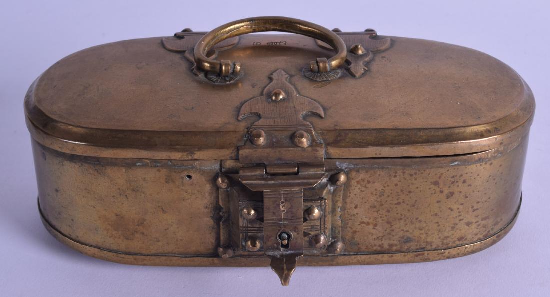 AN 18TH CENTURY ISLAMIC OVAL BRASS TRAVELLING BOX with: AN 18TH CENTURY ISLAMIC OVAL BRASS TRAVELLING BOX with square form lock. 19 cm wide.