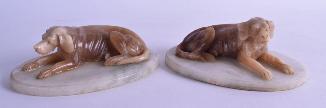A PAIR OF LATE 19TH/20TH CENTURY EUROPEAN ALABASTER: A PAIR OF LATE 19TH/20TH CENTURY EUROPEAN ALABASTER FIGURES OF HOUNDS modelled upon oval bases. 14 cm wide.