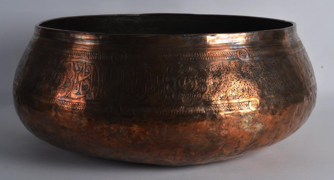 A Large Persian or Syrian Bowl, 10th/12th Century,: A Large Persian or Syrian Bowl, 10th/12th Century, engraved all over with stylised motifs and vines. 1Ft 4.5ins diameter.