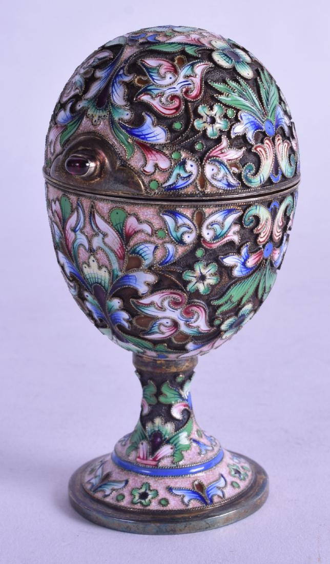 A GOOD RUSSIAN SILVER GILT AND ENAMEL EGG CUP AND COVER: A GOOD RUSSIAN SILVER GILT AND ENAMEL EGG CUP AND COVER with jewelled button, decorated with extensive foliage. 3.5 oz. 8.5 cm high.