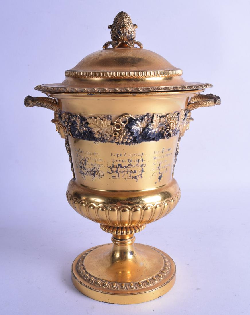 A GOOD EDWARDIAN SILVER GILT TWIN HANDLED VASE AND: A GOOD EDWARDIAN SILVER GILT TWIN HANDLED VASE AND COVER presented to George Woolsey. London 1903. 50.5 oz. 27.5 cm high.