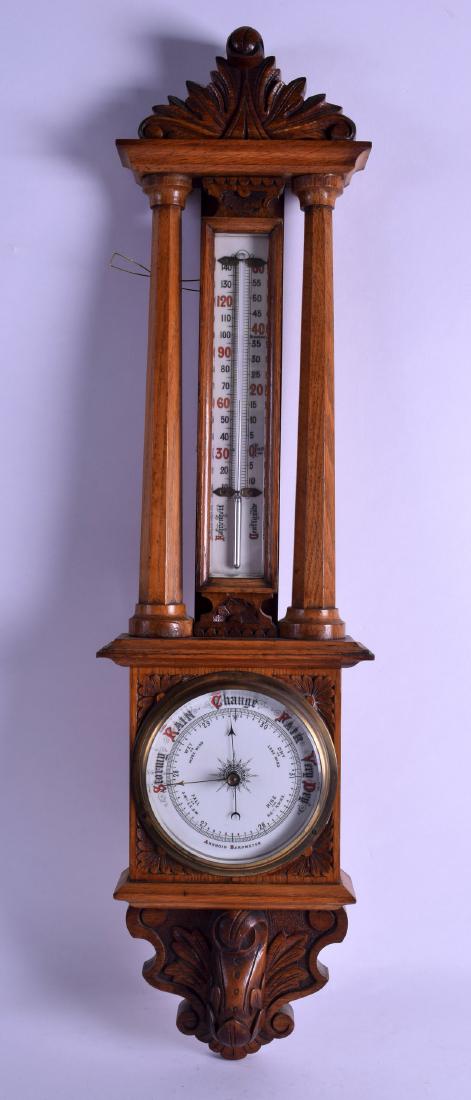 A LATE VICTORIAN/EDWARDIAN OAK ANEROID BAROMETER. 75 cm (1 of 2)