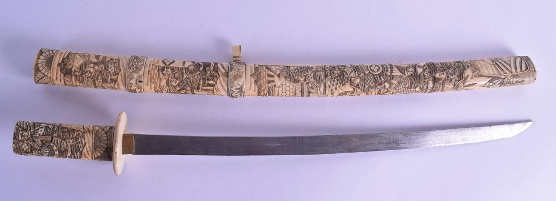 A 19TH CENTURY JAPANESE MEIJI PERIOD CARVED BONE SWORD: A 19TH CENTURY JAPANESE MEIJI PERIOD CARVED BONE SWORD decorated all over with figures in various pursuits. 75 cm long.
