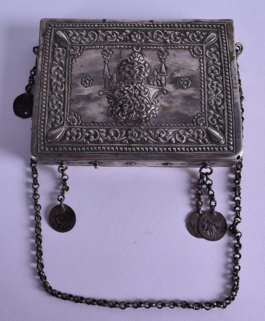 A 19TH CENTURY TURKISH OTTOMAN RECTANGULAR KORAN BOX: A 19TH CENTURY TURKISH OTTOMAN RECTANGULAR KORAN BOX possibly silver, decorated in relief with foliage and a building. 11 cm x 8.25 cm.