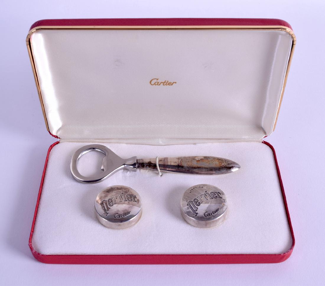 AN UNUSUAL CASED CARTIER SILVER BOTTLE OPENER with: AN UNUSUAL CASED CARTIER SILVER BOTTLE OPENER with matching perrier silver covers. (3)