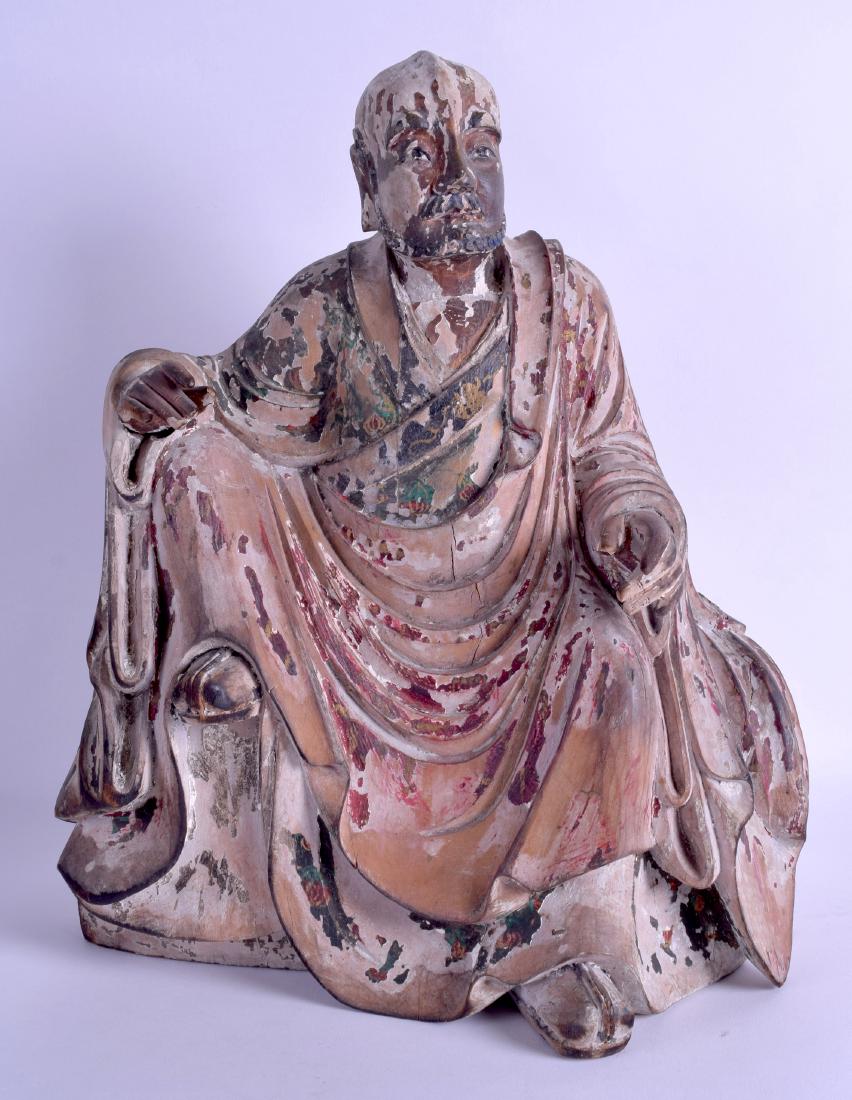 A GOOD 17TH/18TH CENTURY CHINESE POLYCHROMED WOODEN: A GOOD 17TH/18TH CENTURY CHINESE POLYCHROMED WOODEN FIGURE OF A SCHOLAR modelled with one foot raised. 26 cm x 38 cm.