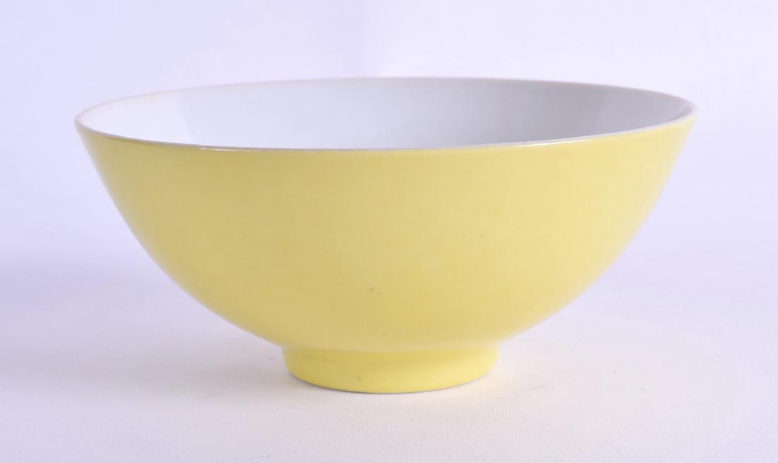 A FINE CHINESE IMPERIAL YELLOW GROUND PORCELAIN BOWL: A FINE CHINESE IMPERIAL YELLOW GROUND PORCELAIN BOWL Yongzheng mark and probably of the period, of plain form, the interior painted with a floral spray. 11.5 cm diameter.