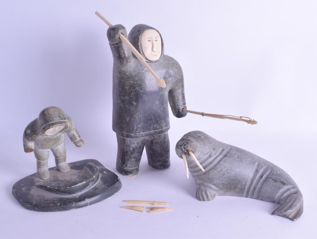 A GOOD GROUP OF THREE CANADIAN INUIT SOAPSTONE AND: A GOOD GROUP OF THREE CANADIAN INUIT SOAPSTONE AND CARVED BONE FIGURES depicting a hunter, whale and young boy peering into a pool. Largest 21 cm high. (3)