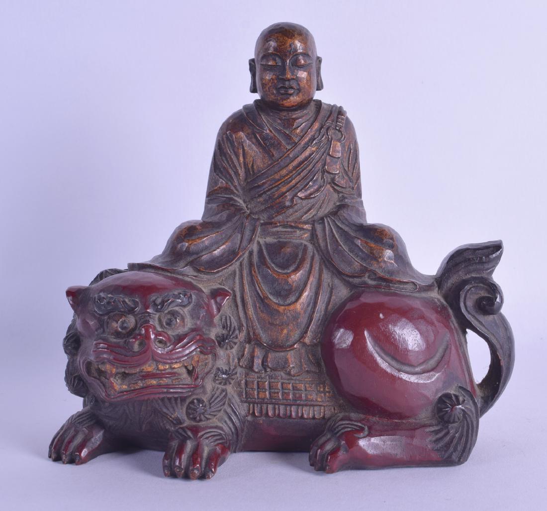 AN EARLY 19TH CENTURY JAPANESE EDO PERIOD CARVED AND: AN EARLY 19TH CENTURY JAPANESE EDO PERIOD CARVED AND LACQUERED BUDDHA modelled seated upon a buddhistic lion. 15 cm x 15 cm.