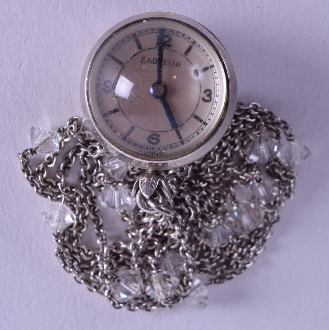 AN EARLY 20TH CENTURY SILVER MOUNTED GUBELIN BALL CLOCK: AN EARLY 20TH CENTURY SILVER MOUNTED GUBELIN BALL CLOCK with white metal chain. 1.75 cm wide.