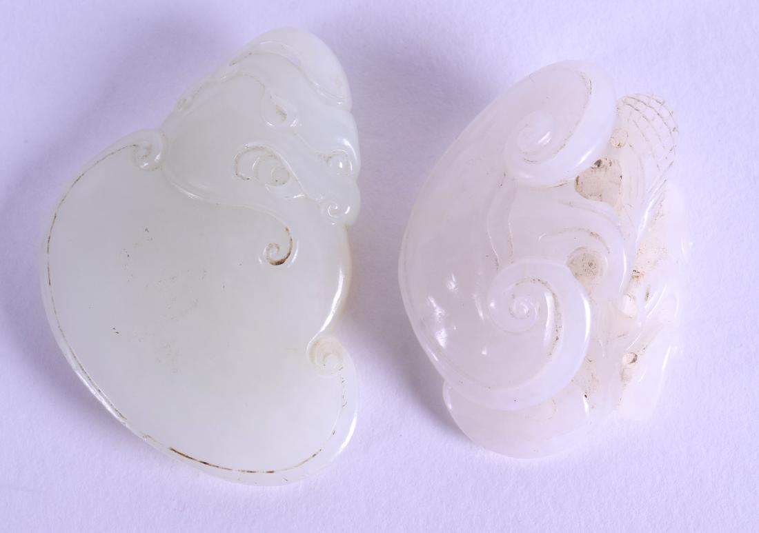 A CHINESE CARVED WHITE JADE LINGZHI FUNGUS together: A CHINESE CARVED WHITE JADE LINGZHI FUNGUS together with another pale green plaque plaque. 5 cm & 5.75 cm wide. (2)