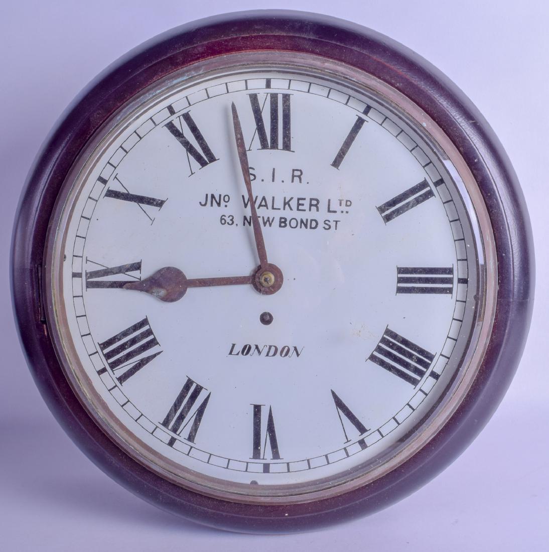 A MAHOGANY HANGING WALL CLOCK signed S.I.R John Walker: A MAHOGANY HANGING WALL CLOCK signed S.I.R John Walker Ltd, 63 New Bond Street. 41 cm wide.