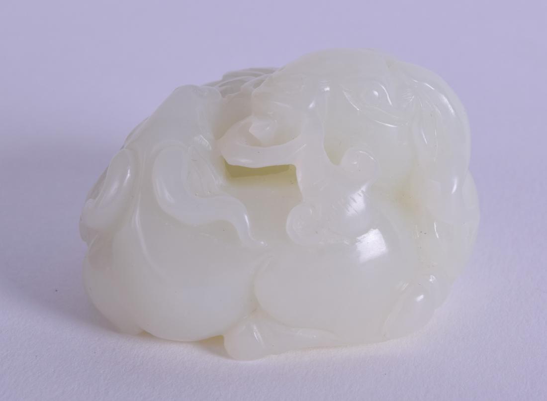 A CHINESE CARVED GREENISH WHITE JADE FIGURE OF A RAM (1 of 3)