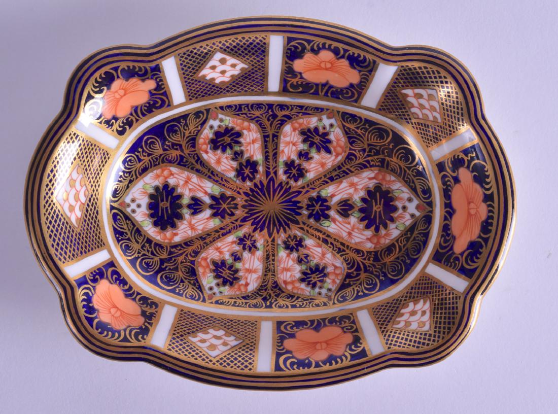 A ROYAL CROWN DERBY IMARI DISH painted with flowers. (1 of 2)
