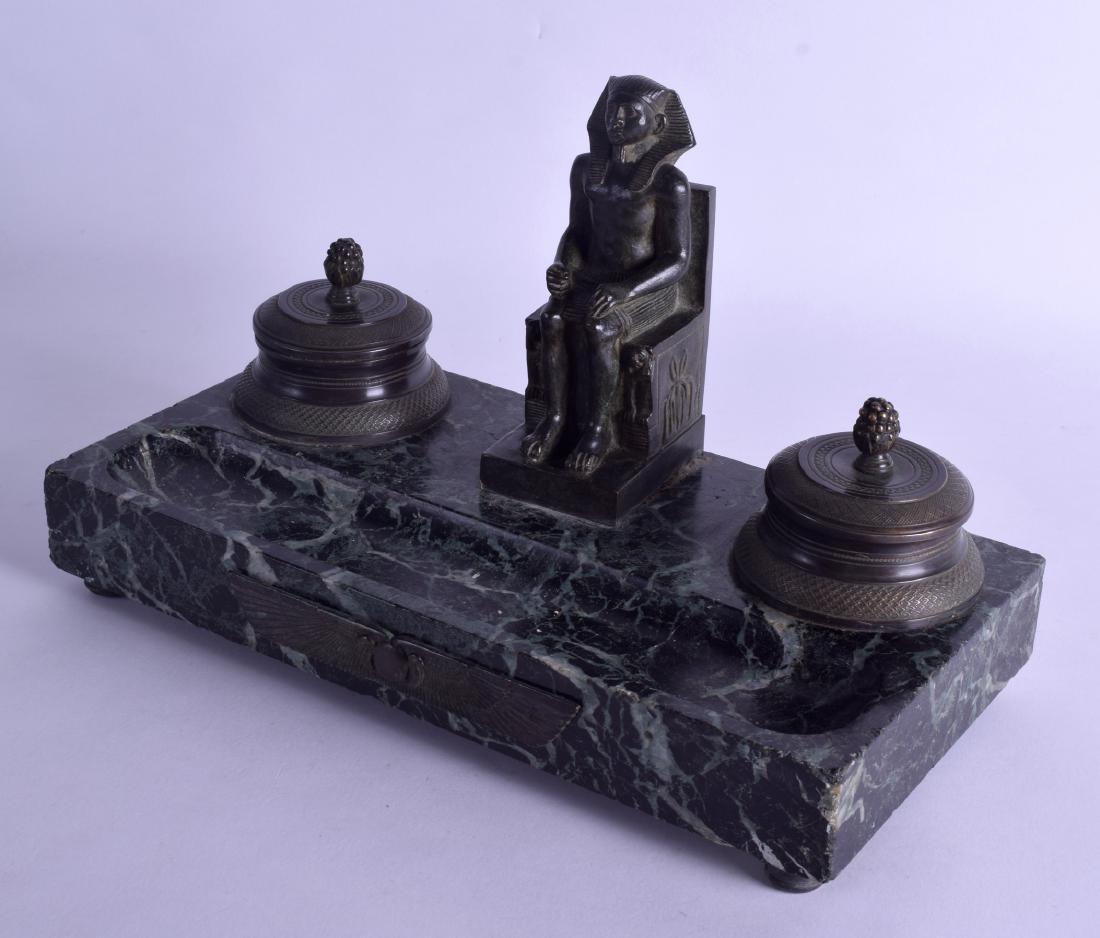 A 19TH CENTURY FRENCH EGYPTIAN REVIVAL BRONZE AND: A 19TH CENTURY FRENCH EGYPTIAN REVIVAL BRONZE AND MARBLE INKWELL modelled with a seated pharaoh upon a rectangular base. 31 cm wide.