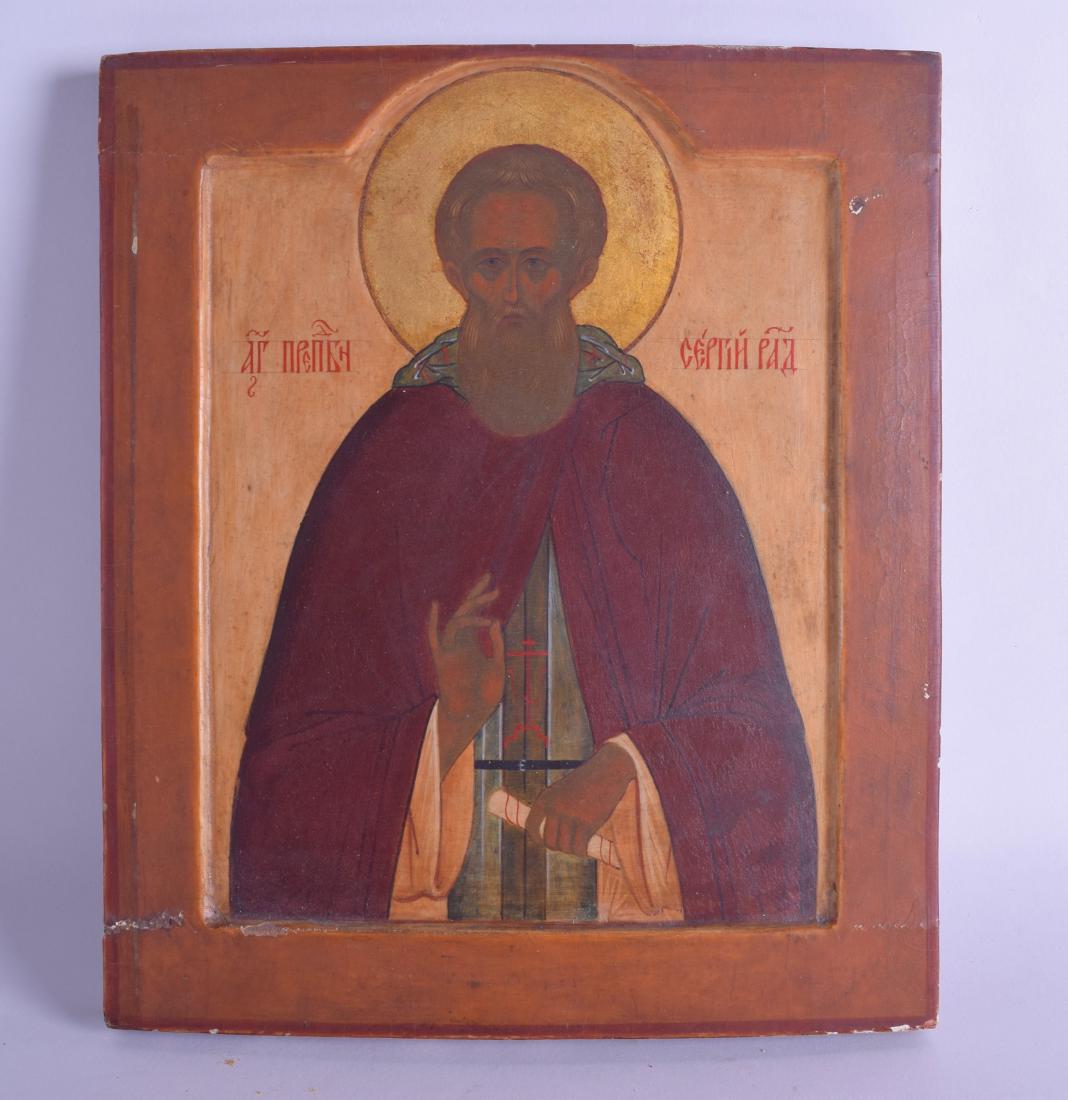 A 19TH CENTURY RUSSIAN PAINTED WOODEN ICON painted with (1 of 2)