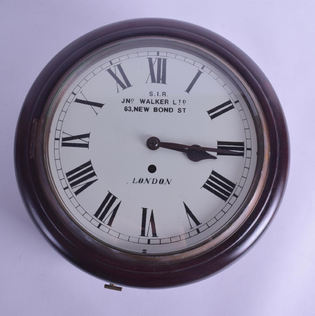 A MAHOGANY FUSSEE WALL CLOCK signed S I R John Walker: A MAHOGANY FUSSEE WALL CLOCK signed S I R John Walker Ltd New Bond Street. 31 cm x 31 cm.