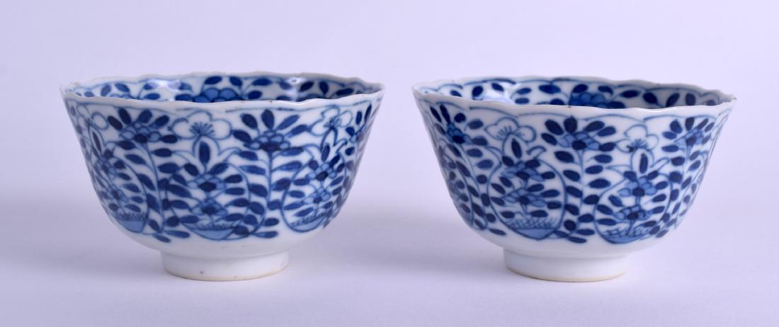 A PAIR OF 19TH CENTURY CHINESE BLUE AND WHITE SCALLOPED: A PAIR OF 19TH CENTURY CHINESE BLUE AND WHITE SCALLOPED TEABOWLS bearing Qianlong marks to base, painted with floral sprays. 8.75 cm wide.