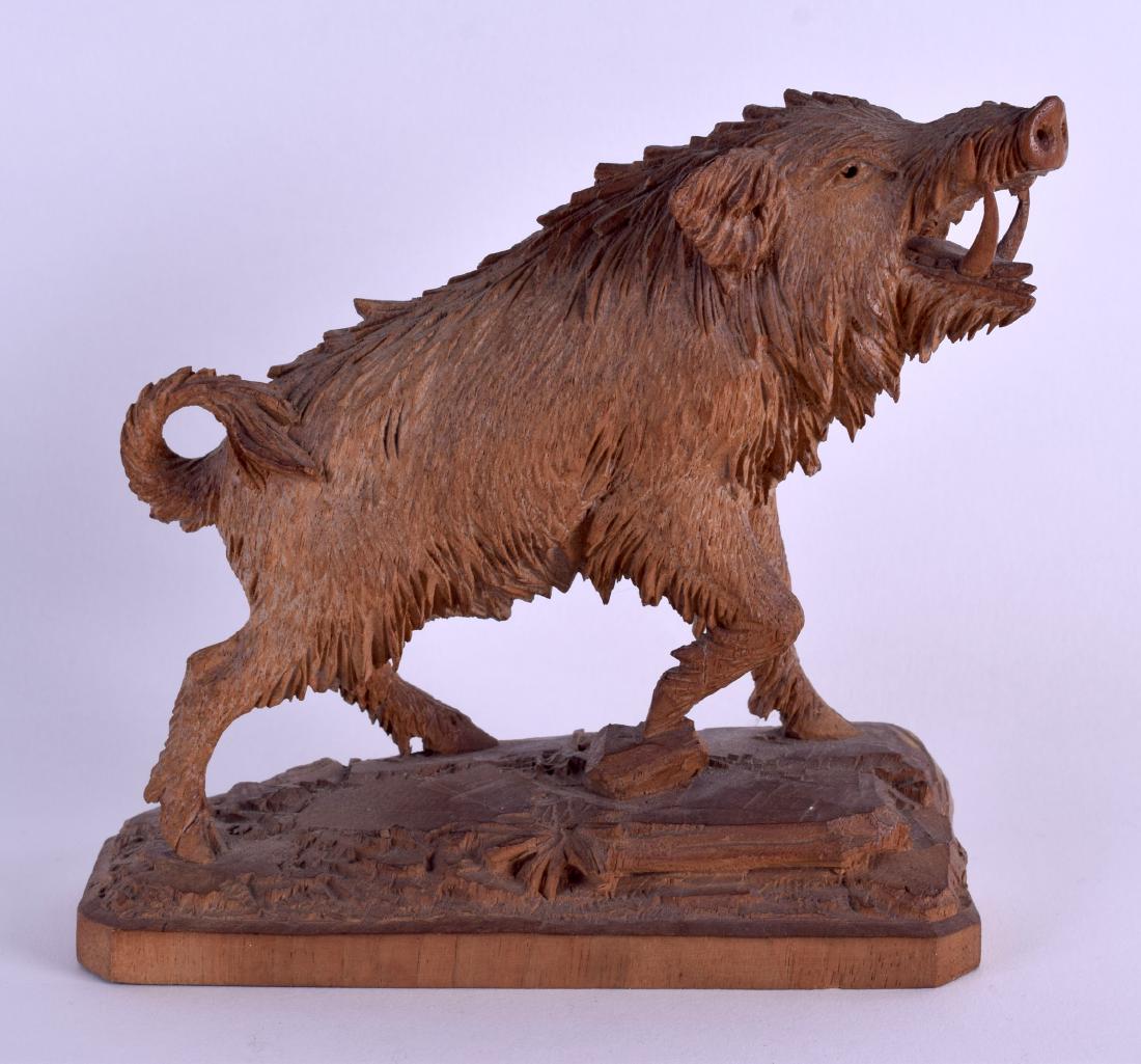 A GOOD LATE 19TH CENTURY BAVARIAN CARVED BLACK FOREST: A GOOD LATE 19TH CENTURY BAVARIAN CARVED BLACK FOREST FIGURE OF A WILD BOAR modelled upon a naturalistic base. 14 cm x 14 cm.