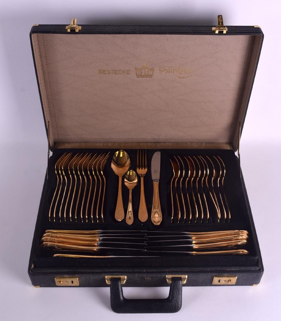 A CASED SEVENTY PIECE SET OF GOLD PLATED SOLINGEN: A CASED SEVENTY PIECE SET OF GOLD PLATED SOLINGEN CUTLERY with beaded border handles. (70)