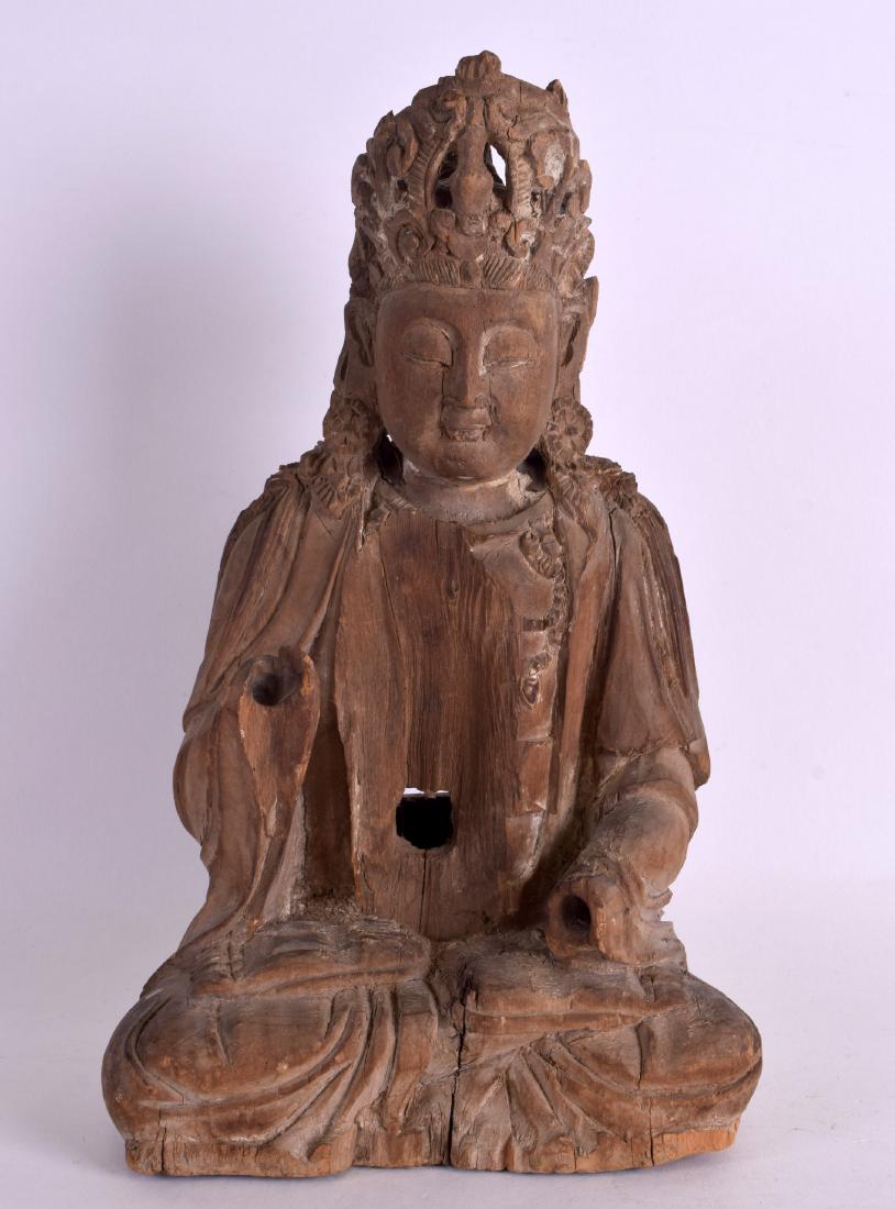 A CHINESE YUAN/MING DYNASTY CARVED WOOD FIGURE OF A: A CHINESE YUAN/MING DYNASTY CARVED WOOD FIGURE OF A SEATED BUDDHA elegantly modelled with an arm raised in flowing robes. 26 cm x 14.5 cm.