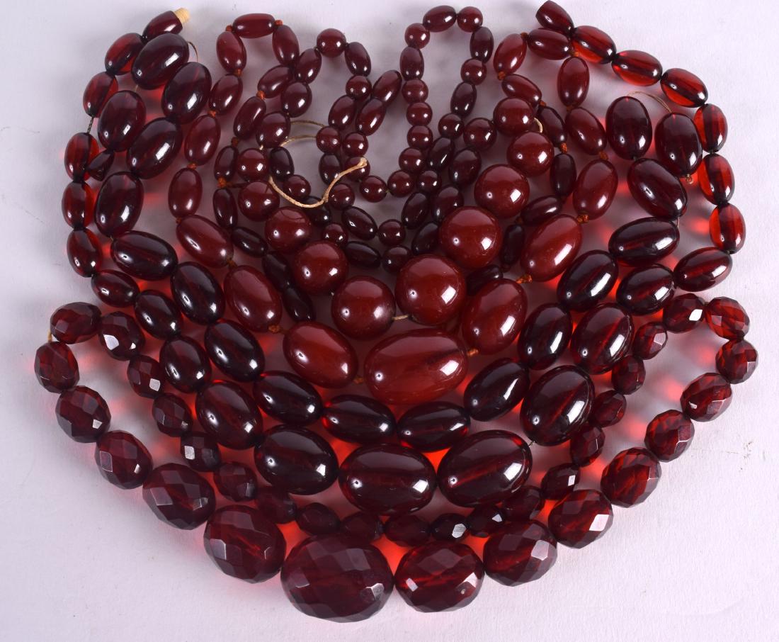 FOUR EARLY 20TH CENTURY CARVED AMBER NECKLACE. 280 (1 of 3)