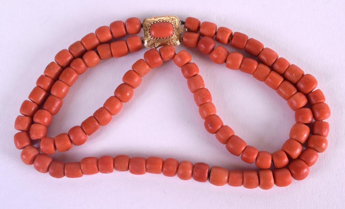 AN 18CT GOLD CARVED RED CORAL DOUBLE STRAND NECKLACE. (1 of 2)
