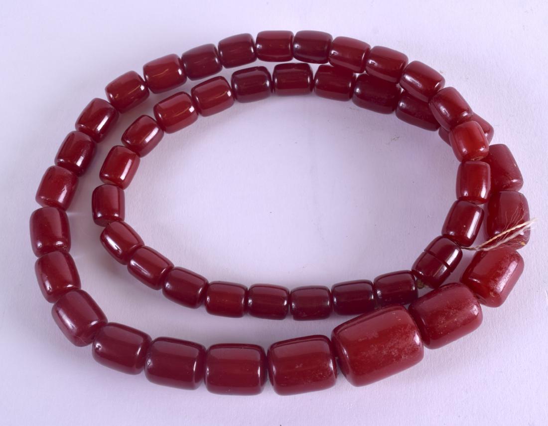 A LONG HEAVY CHERRY AMBER NECKLACE. 127 grams. 76 cm (1 of 2)