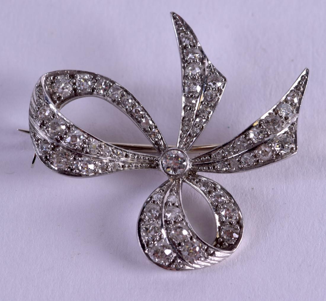 AN ART DECO PLATINUM AND DIAMOND BOW BAR BROOCH the (1 of 2)