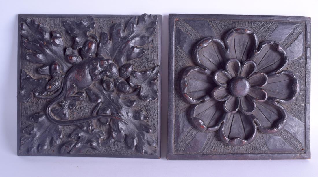 A PAIR OF 19TH CENTURY NORWEGIAN CARVED WOOD PANELS one: A PAIR OF 19TH CENTURY NORWEGIAN CARVED WOOD PANELS one depicting a rat eating acorns, the other a bold flower. 22 cm x 22 cm.