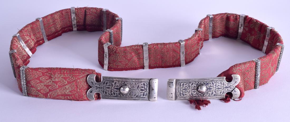 A 19TH CENTURY RUSSIAN NIELLO DECORATED BELT the clasp: A 19TH CENTURY RUSSIAN NIELLO DECORATED BELT the clasp by Sergey Agafonov, the silver banding with varying maker, decorated with foliage and vines. 115 cm long.