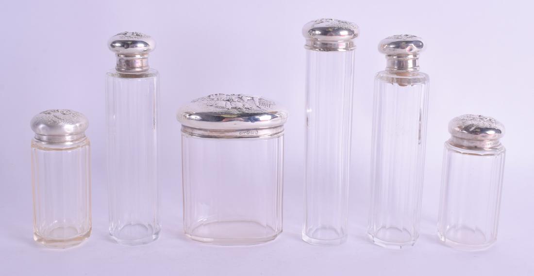 SIX EDWARDIAN SILVER TOPPED DRESSING TABLE JARS.: SIX EDWARDIAN SILVER TOPPED DRESSING TABLE JARS. Birmingham 1910. Largest 13 cm high. (6)
