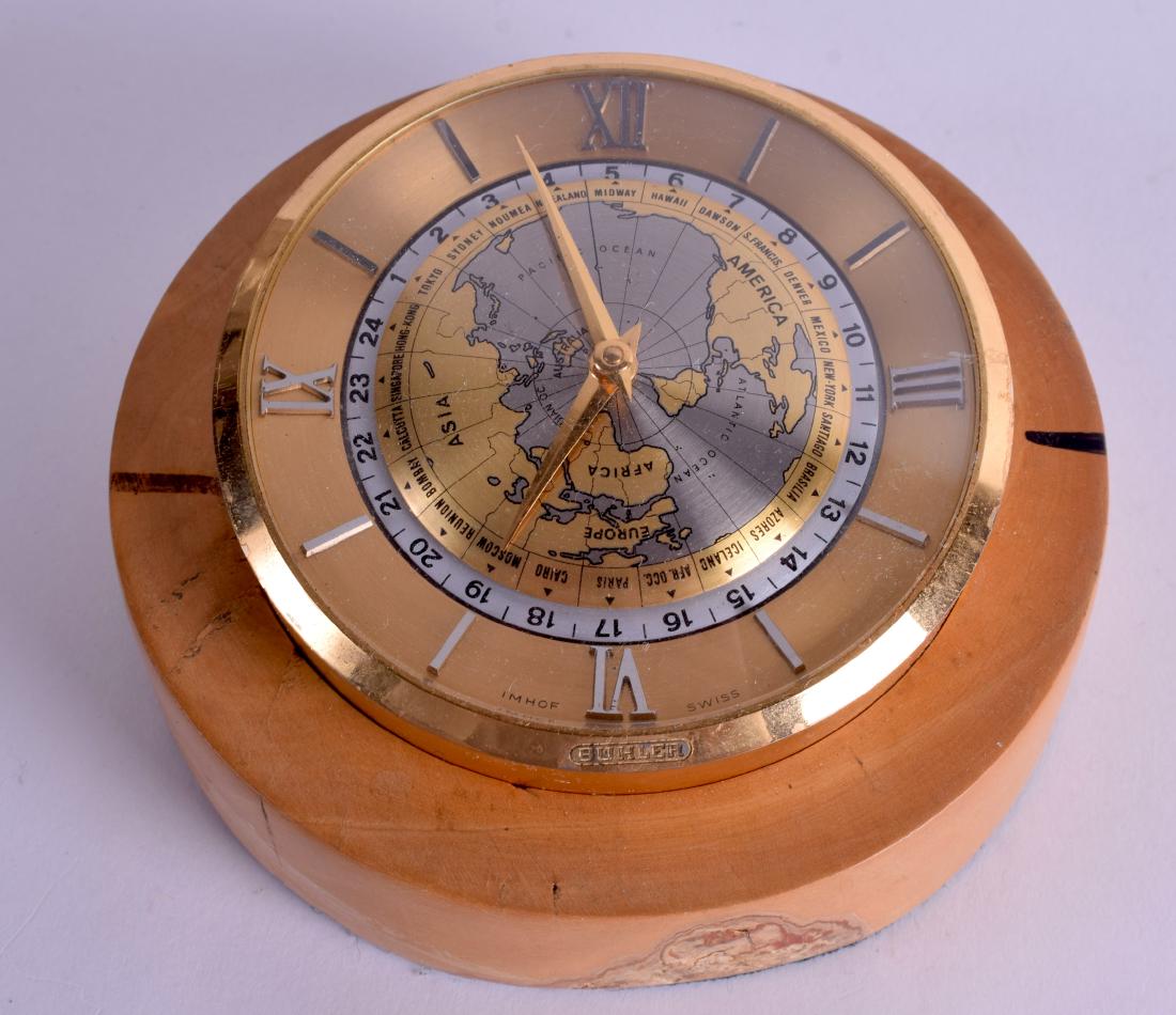 A RETRO BUHLER DESK CLOCK with globe and silvered: A RETRO BUHLER DESK CLOCK with globe and silvered chapter ring. 11 cm wide.