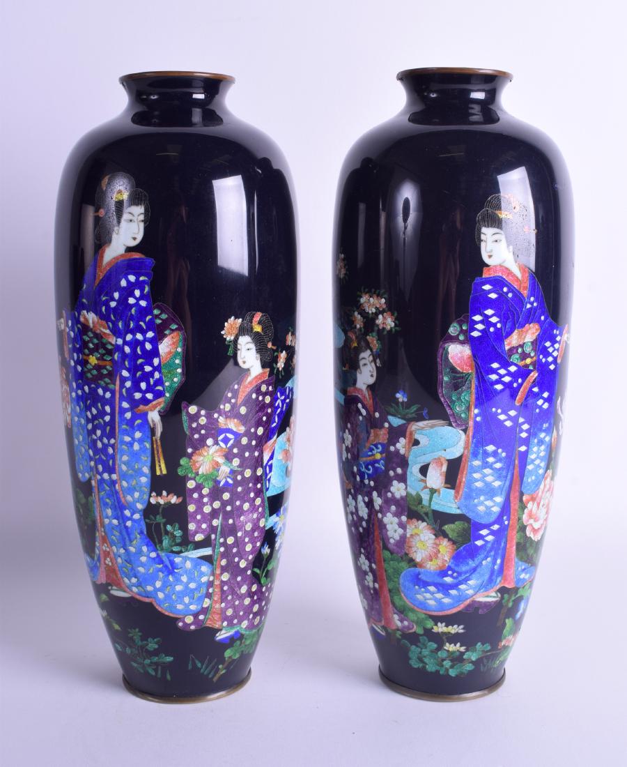A LARGE PAIR OF LATE 19TH CENTURY JAPANESE MEIJI PERIOD: A LARGE PAIR OF LATE 19TH CENTURY JAPANESE MEIJI PERIOD CLOISONNE ENAMEL VASES decorated with geisha within landscapes. 30 cm high.