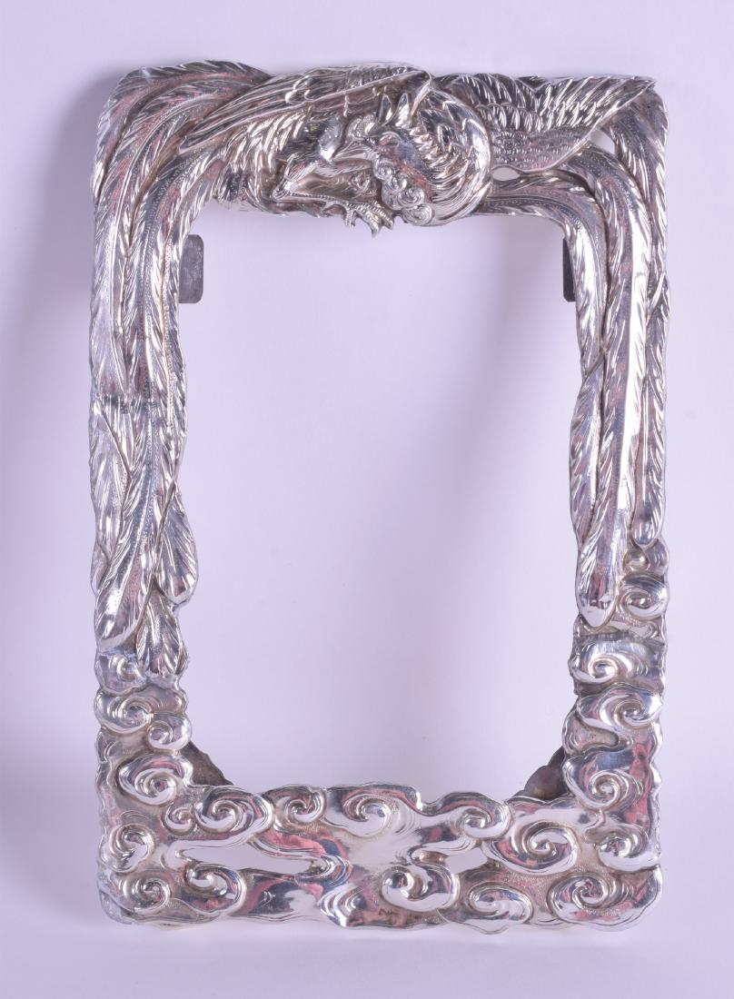 A 19TH CENTURY JAPANESE MEIJI PERIOD SILVER STRUT: A 19TH CENTURY JAPANESE MEIJI PERIOD SILVER STRUT PHOTOGRAPH FRAME decorated with a rising phoenix over clouds. 233 grams. 15 cm x 22 cm.