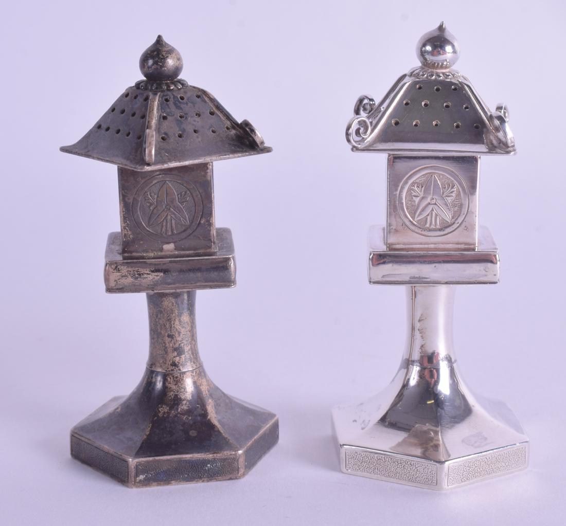A PAIR OF LATE 19TH CENTURY JAPANESE MEIJI PERIOD: A PAIR OF LATE 19TH CENTURY JAPANESE MEIJI PERIOD SILVER PAGODA CONDIMENTS upon hexagonal bases.145 grams. 8.5 cm high.