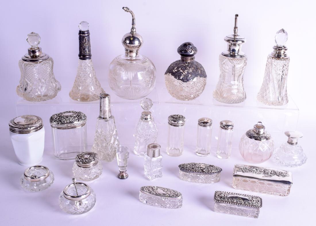 A GROUP OF TWENTY FOUR SILVER TOPPED JARS AND BOTTLES (1 of 1)