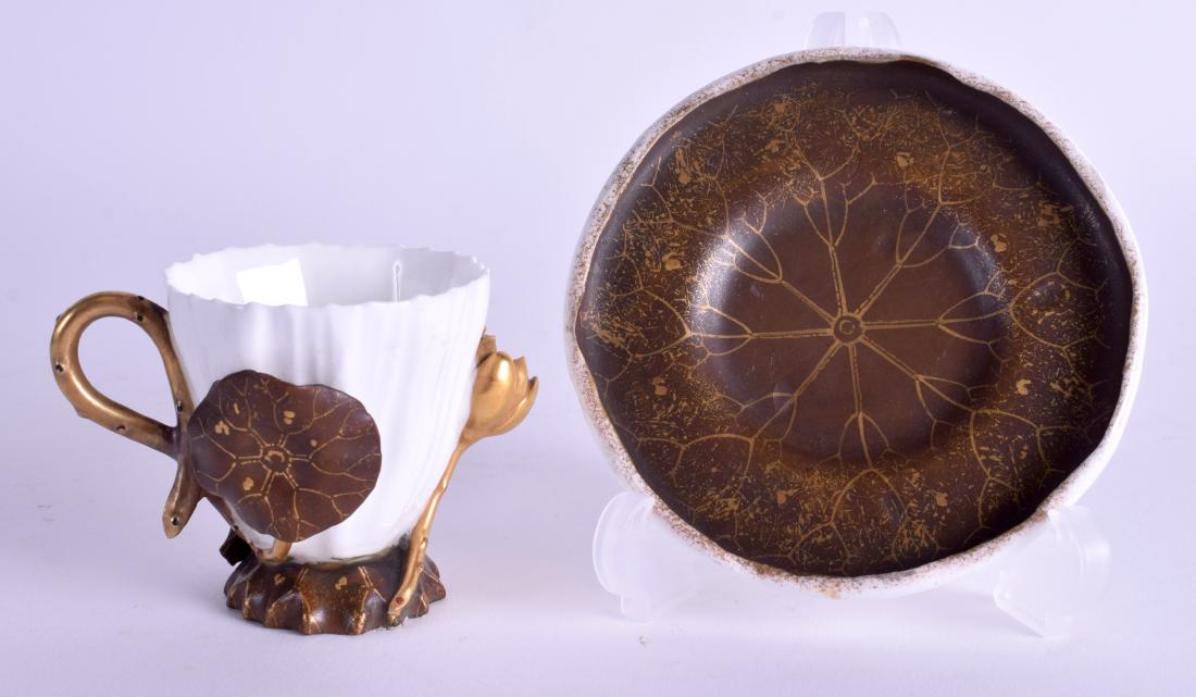 A RARE AESTEHTIC MOVEMENT PORCELAIN CUP AND SAUCER in: A RARE AESTEHTIC MOVEMENT PORCELAIN CUP AND SAUCER in the manner of Royal Worcester. (2)