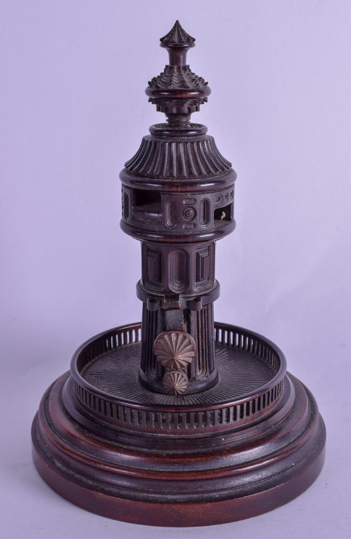 A LOVELY 19TH CENTURY TREEN CARVED WOOD TOWER upon a: A LOVELY 19TH CENTURY TREEN CARVED WOOD TOWER upon a turned mahogany base. 19 cm high.