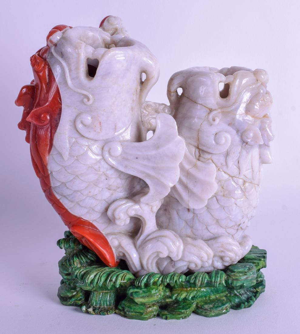 A RARE CHINESE QING DYNASTY CARVED AGATE BRUSH POT: A RARE CHINESE QING DYNASTY CARVED AGATE BRUSH POT modelled as a two carp emerging from a naturalistic pool. 15 cm x 19 cm.