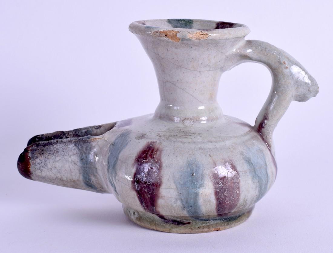 A MIDDLE EASTERN POTTERY JUG. 7 cm wide.: A MIDDLE EASTERN POTTERY JUG. 7 cm wide.