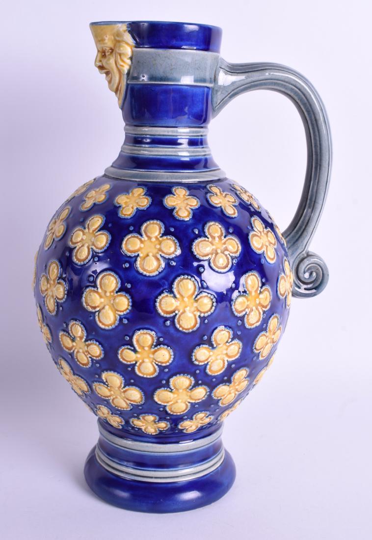 A 19TH CENTURY MINTON POTTERY JUG decorated with floral: A 19TH CENTURY MINTON POTTERY JUG decorated with floral roundels. 25.5 cm high.