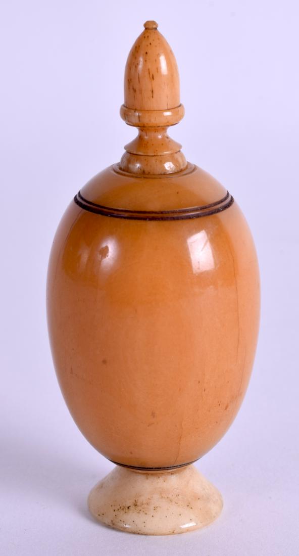 A 19TH CENTURY CARVED HORN SNUFF BOX AND COVER in the: A 19TH CENTURY CARVED HORN SNUFF BOX AND COVER in the form of a vase. 8.5 cm high.