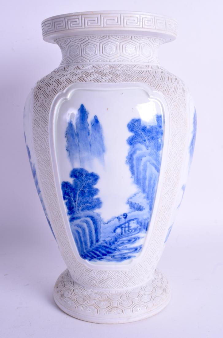 A 19TH CENTURY JAPANESE MEIJI PERIOD HIRADO PORCELAIN: A 19TH CENTURY JAPANESE MEIJI PERIOD HIRADO PORCELAIN VASE painted with panels of landscapes under a raised incised border. 29 cm x 16 cm.